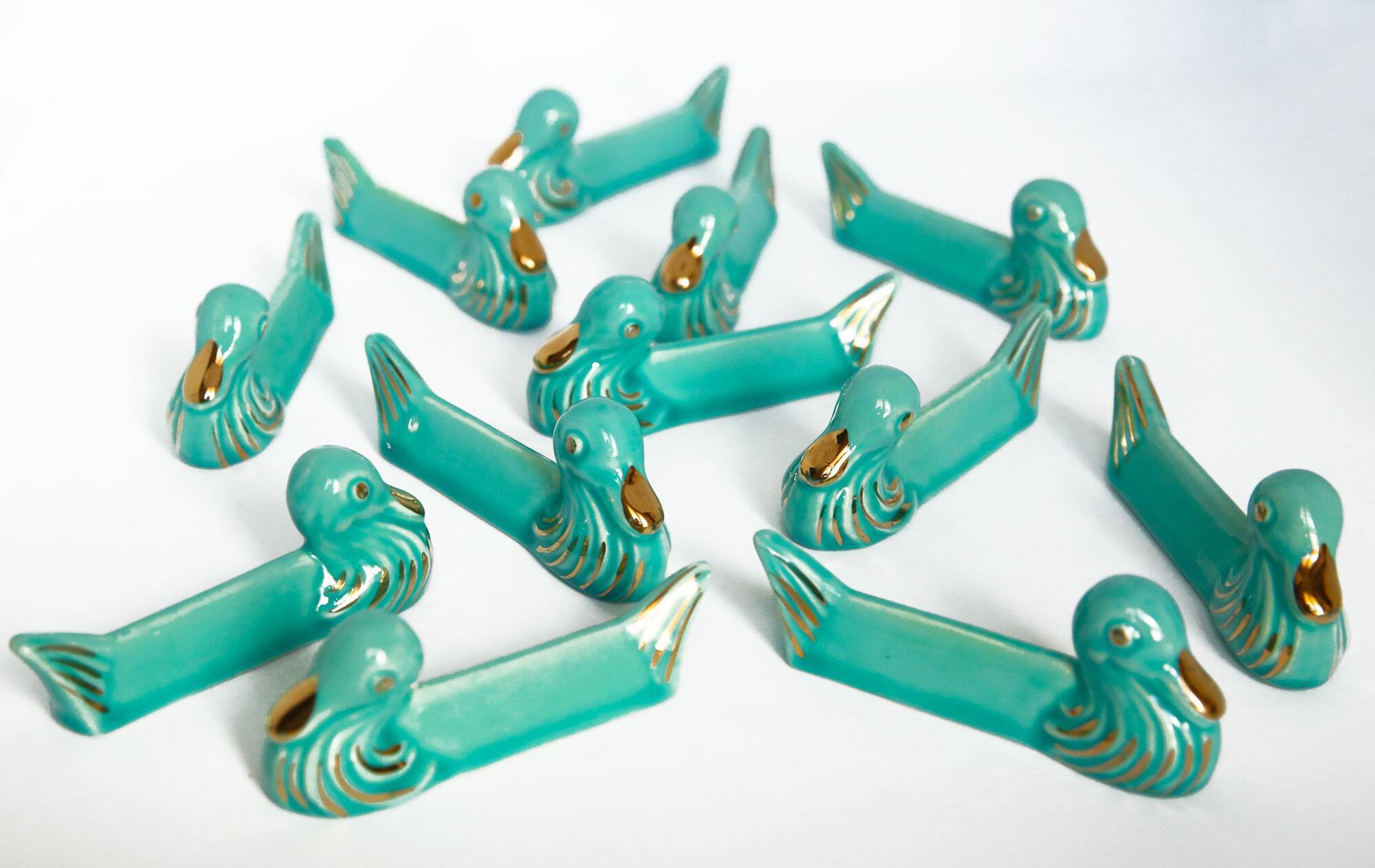 Set of 12 turquoise blue and gold duck knife holders mid-20th century
