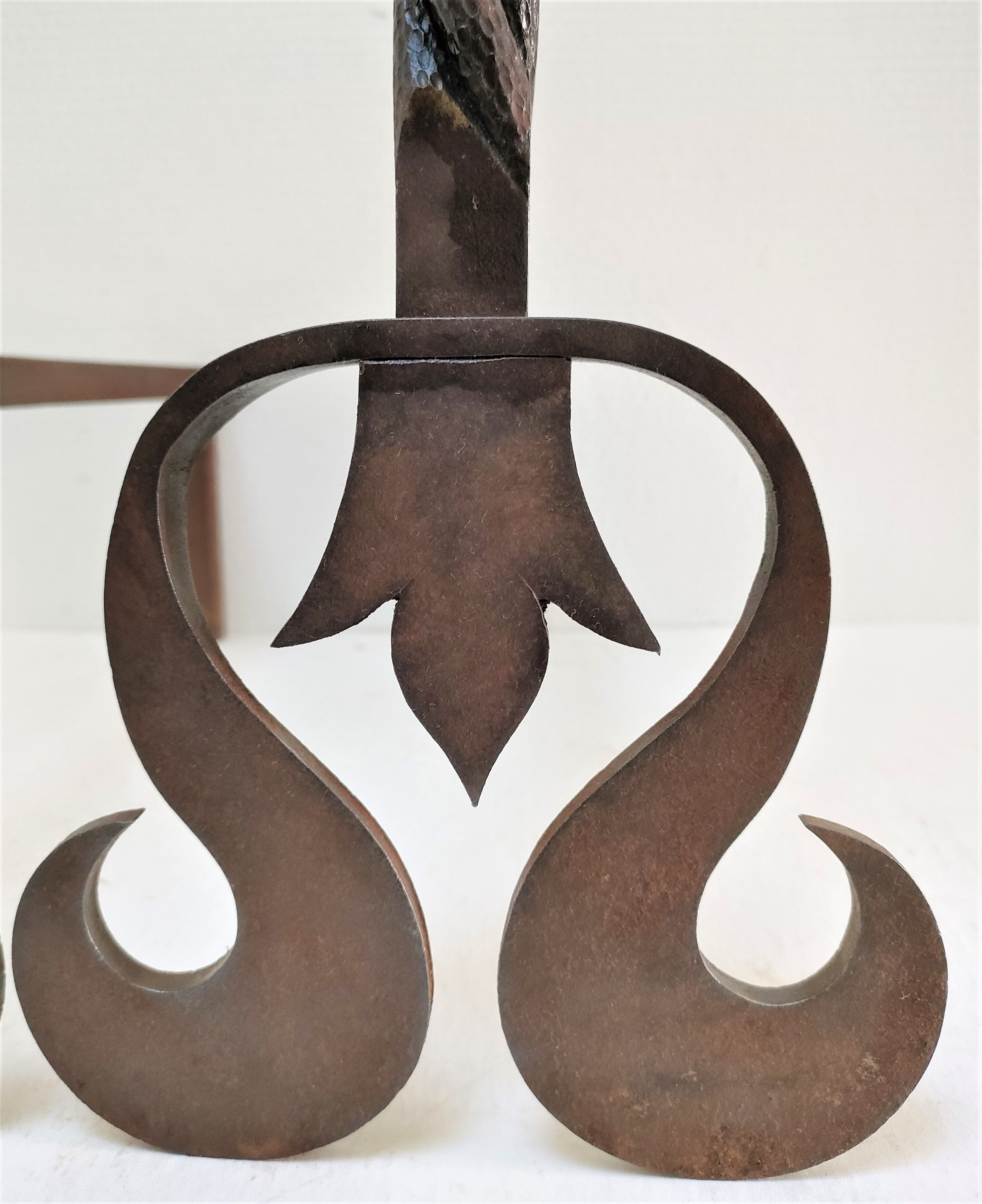 Pair of sculptural cast iron chenets with twisted heads