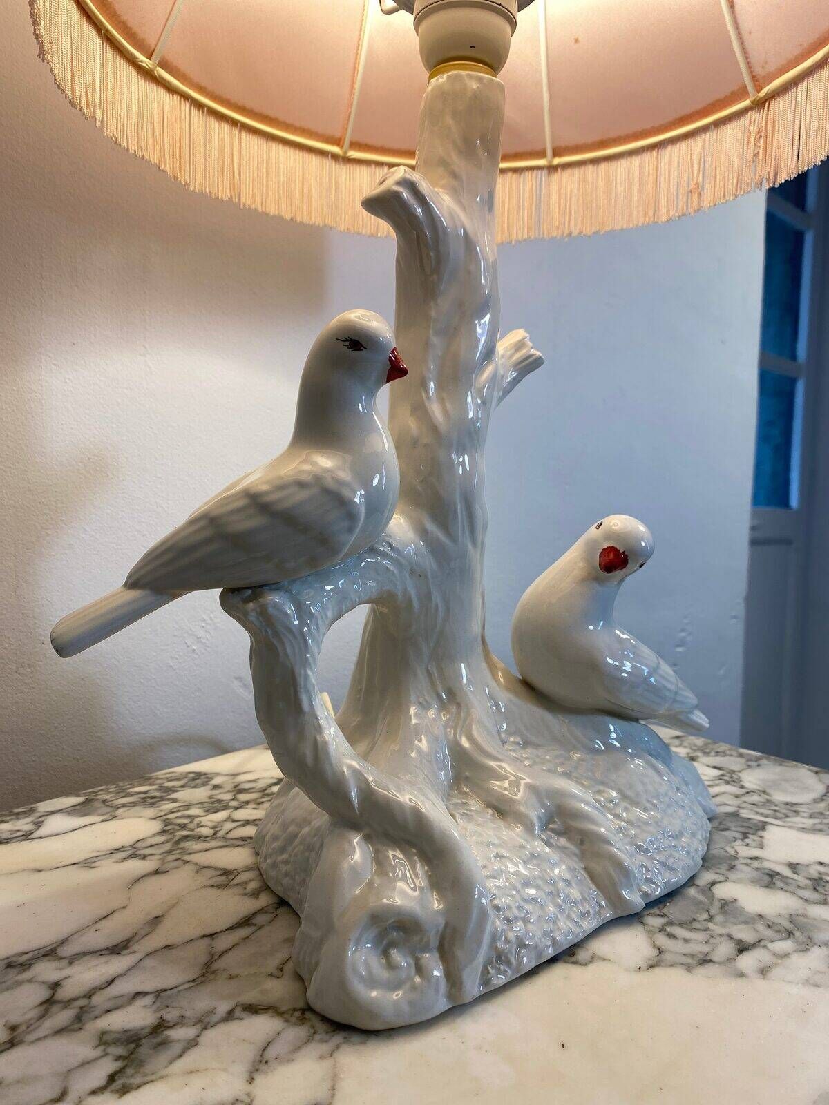 Ceramic lamp with birds, pink fringed shade, 1950s.