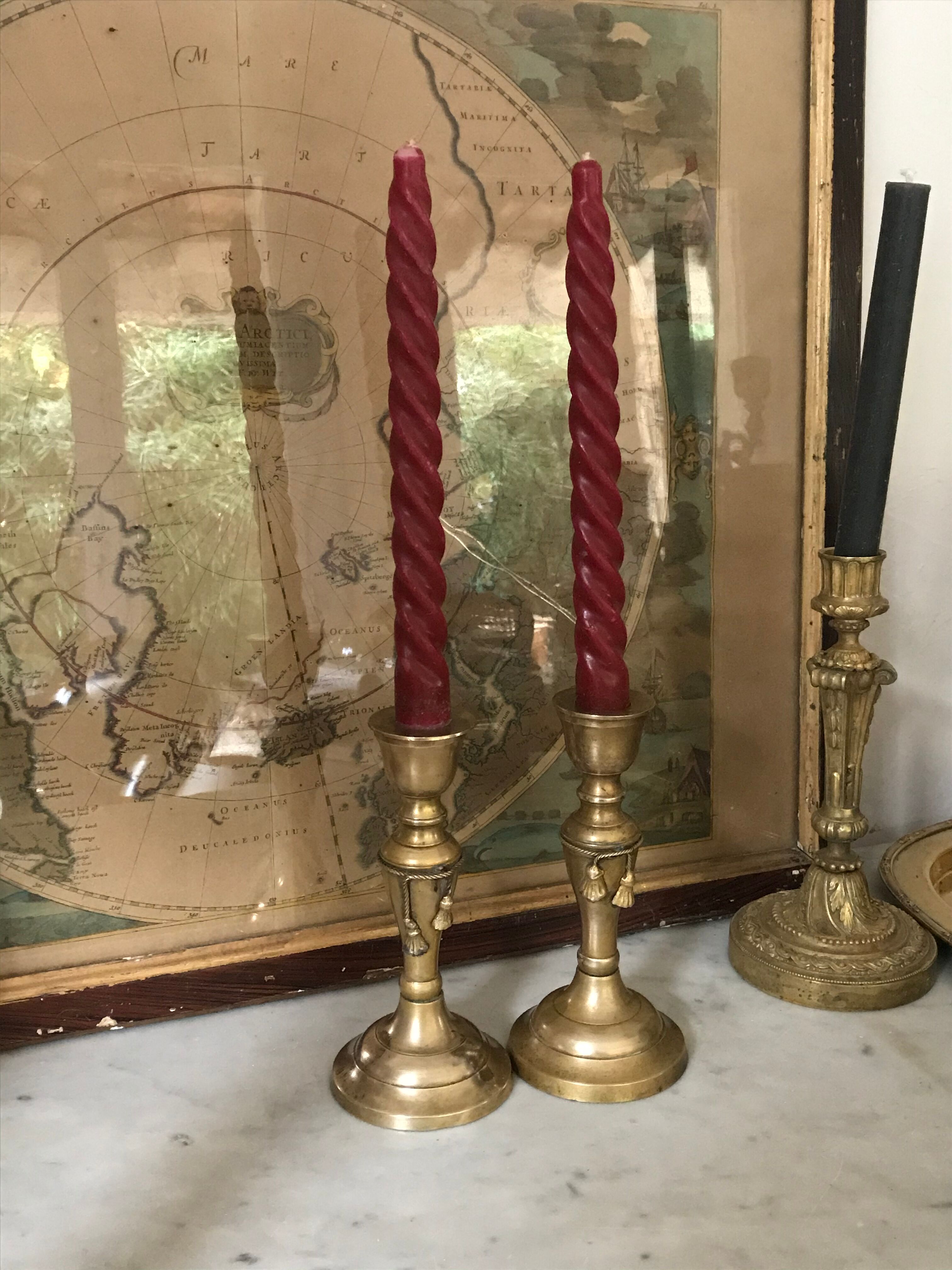 Pair of brass candlesticks with tassels