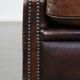 Dark brown sheepskin armchair finished with decorative nails