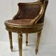 Louis XVI style armchair in wood and gilded stucco, 20th century.