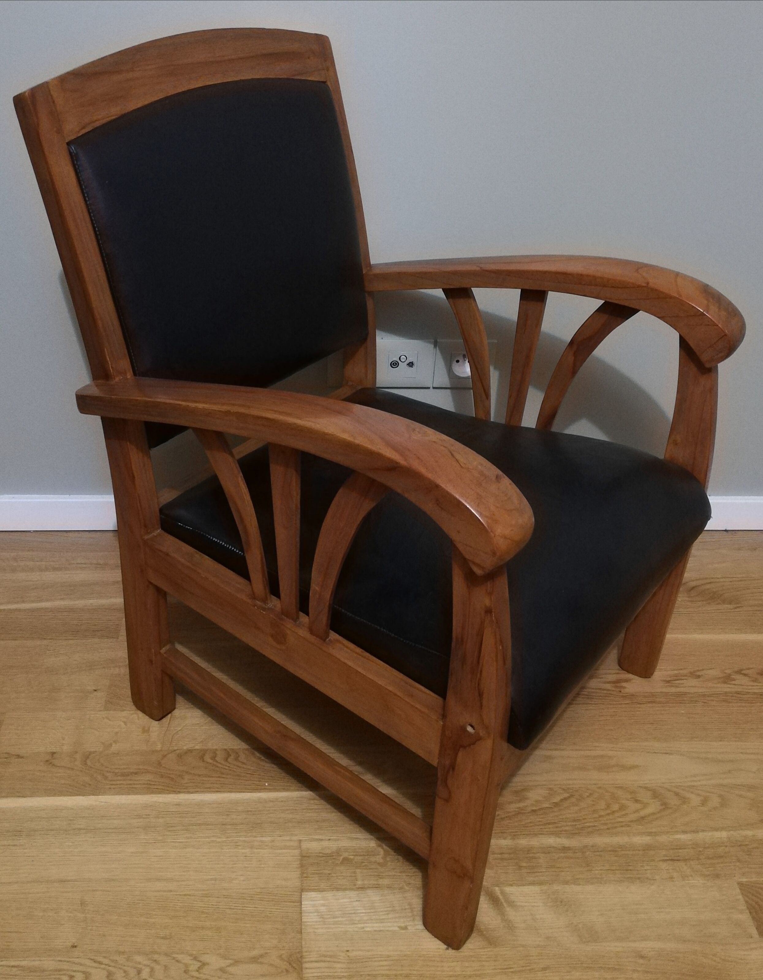 Colonial armchair in teak and black leather