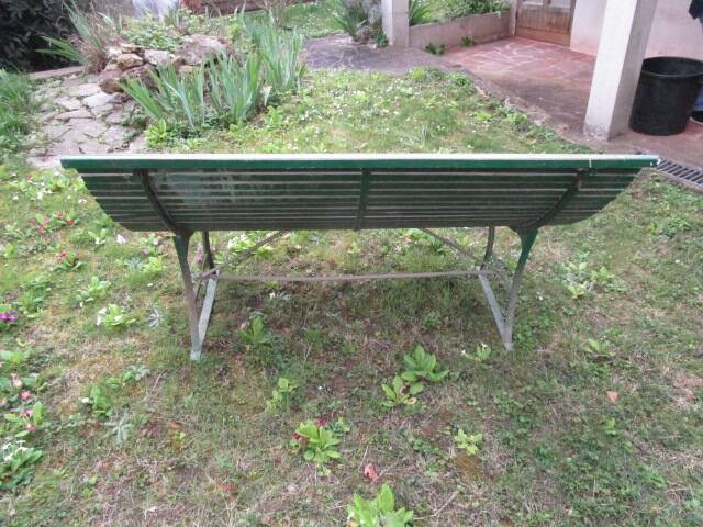 Old metal garden bench with wooden slats