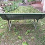 Old metal garden bench with wooden slats
