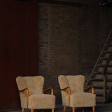 Pair of Mid Century Modern Swedish lounge chairs in birch and lamb's wool, 1960s.