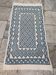 White and blue hand-woven rug in natural wool