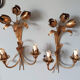 Gold sconces with floral decoration