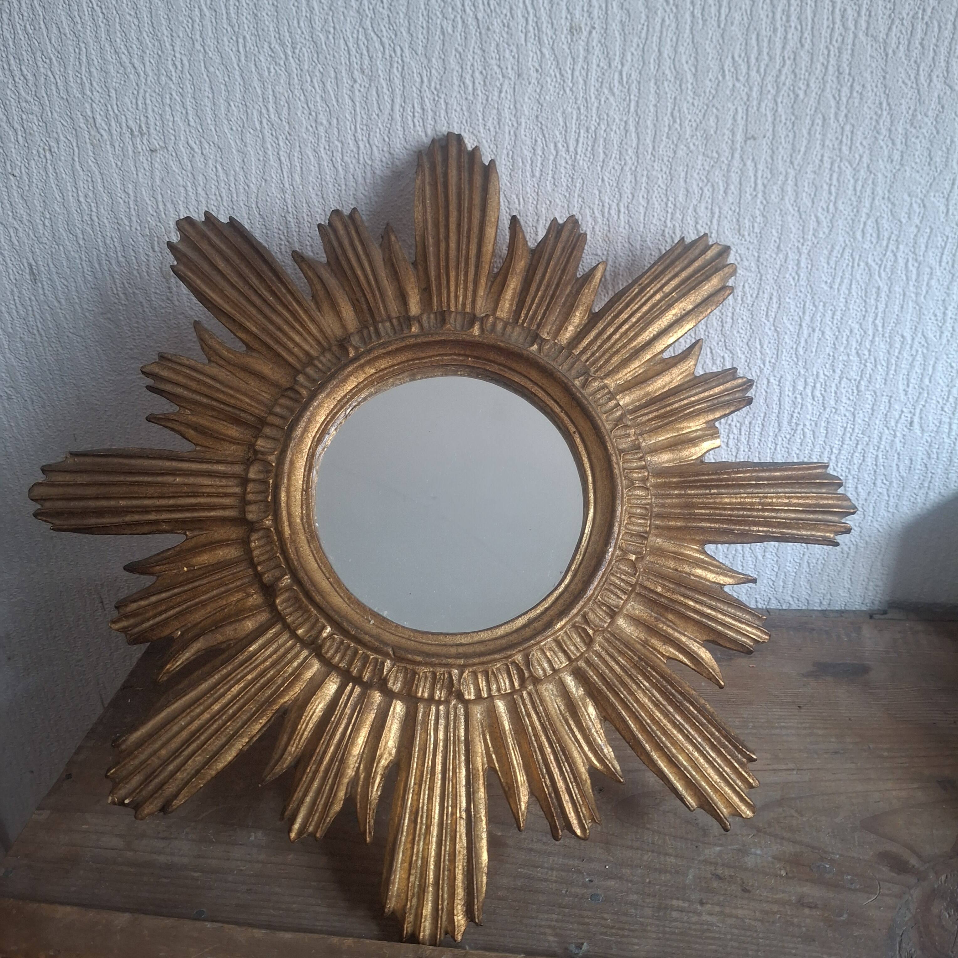 Vintage sun mirror in gilded wood. 1960