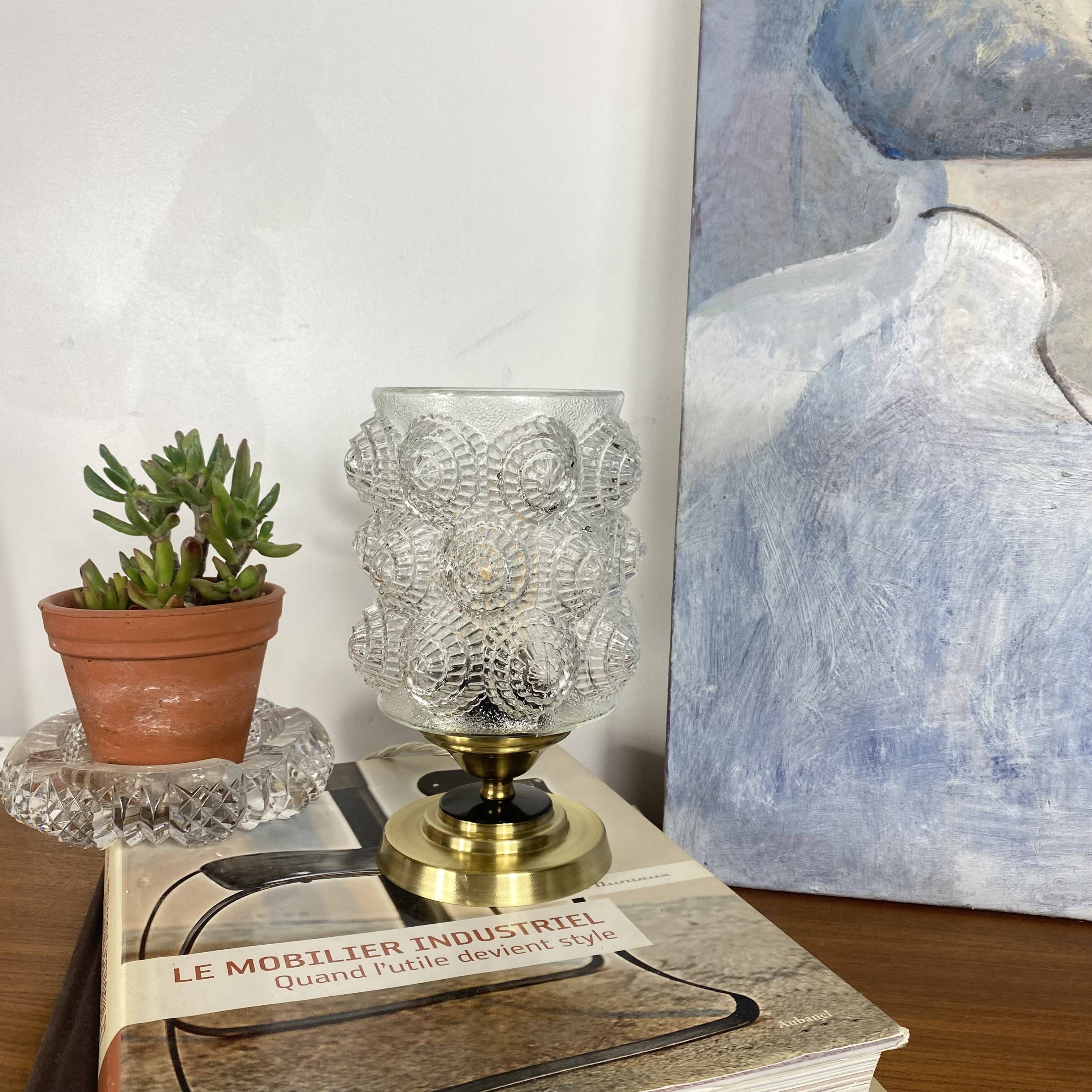 Antique globe table lamp in moulded transparent glass with a brass base.