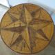 Round coffee table in bamboo, rattan, and wood with an 80s star pattern.