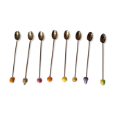 8 golden cocktail spoons with fruit patterns in tip
