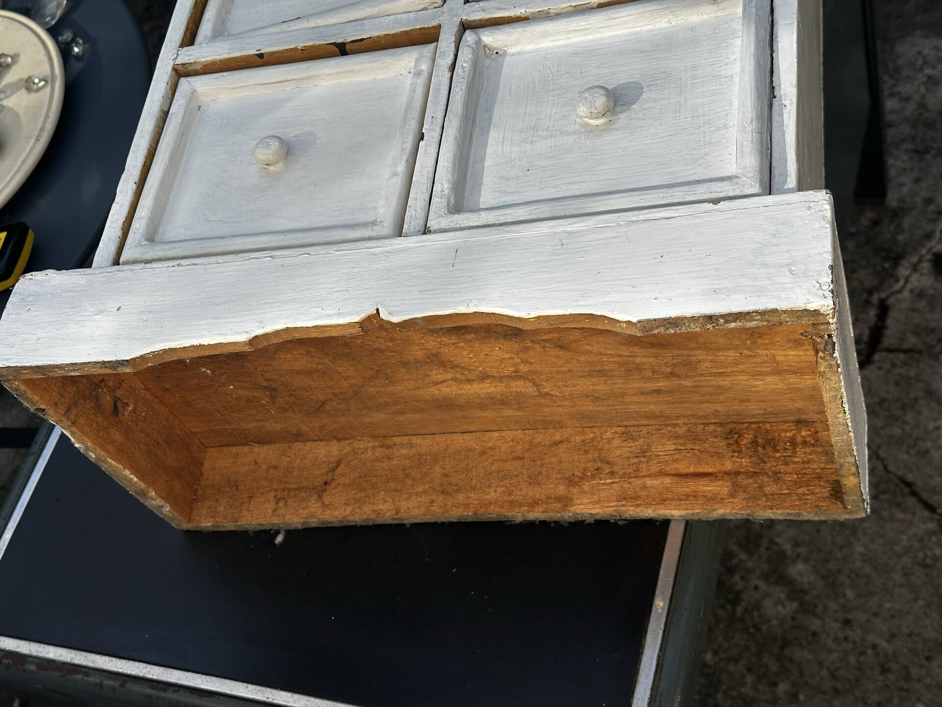 Small antique workshop cabinet with 8 painted wooden drawers.