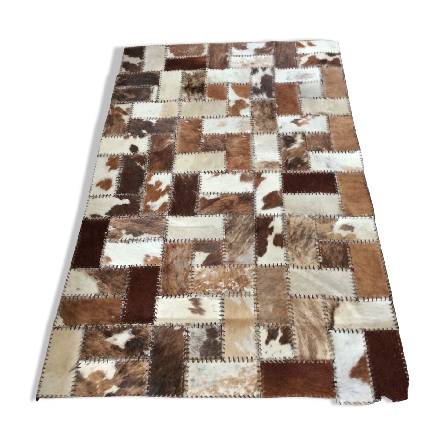 Patchwork carpet in cowhide 164x105cm from the 70s