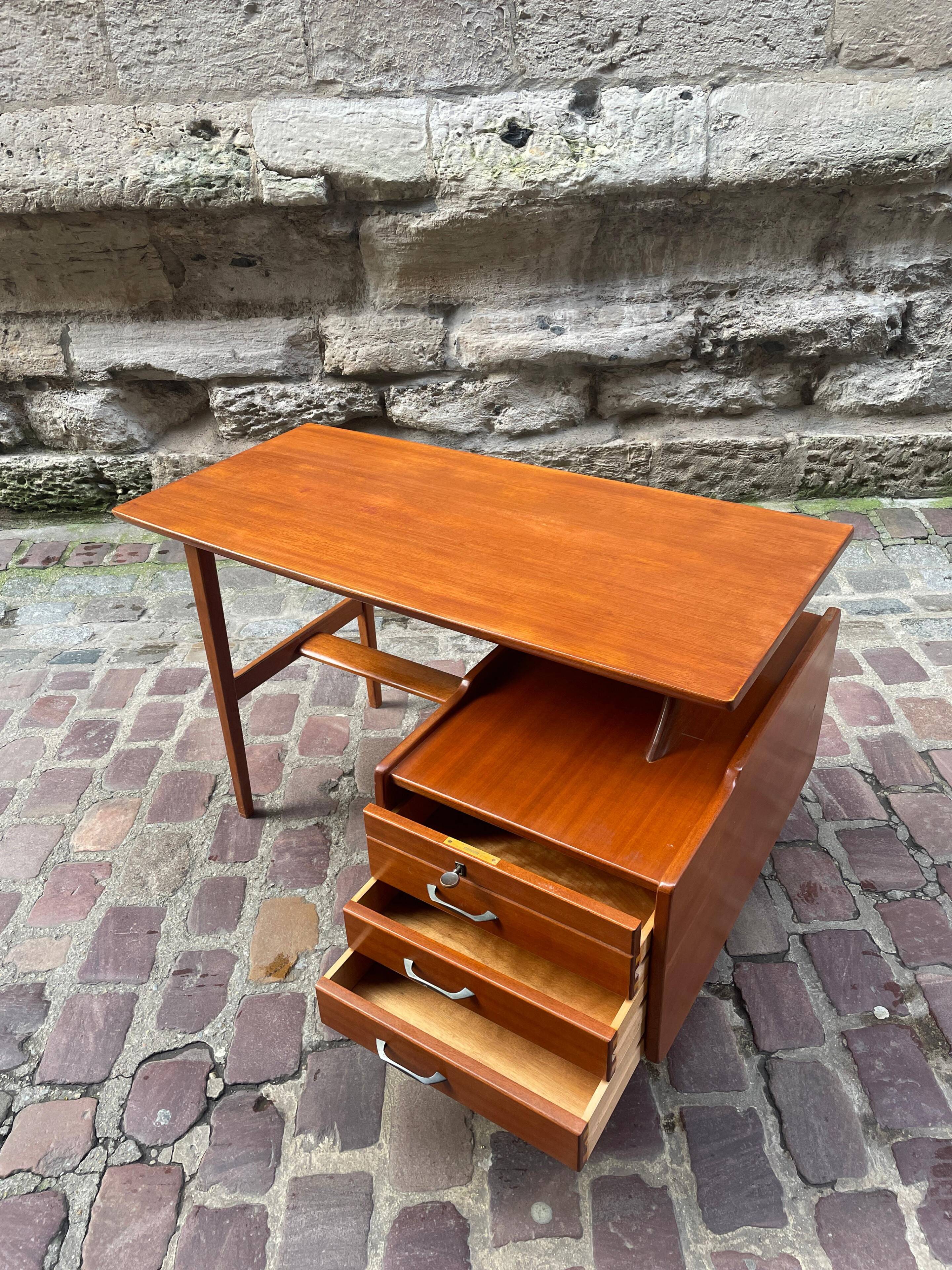 Mahogany desk with drawers by Jacques Hauville published by Bema.