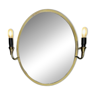 Oval wall mirror in gilded brass with double sconces – 1950s/60s