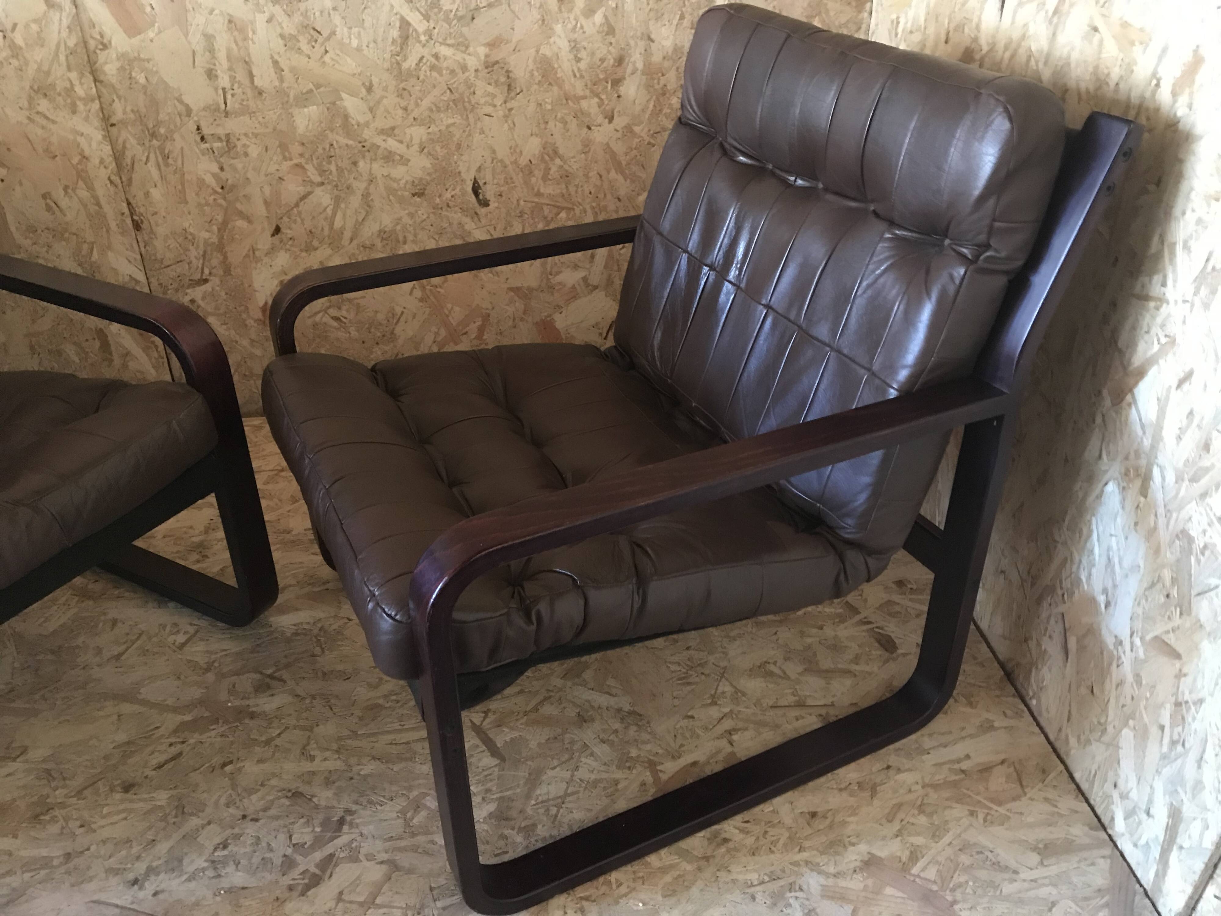 Pair of vintage armchairs in curved wood with suspended seat circa 1970-80.