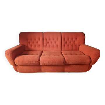 A lot of orange seventies sofas and armchairs.