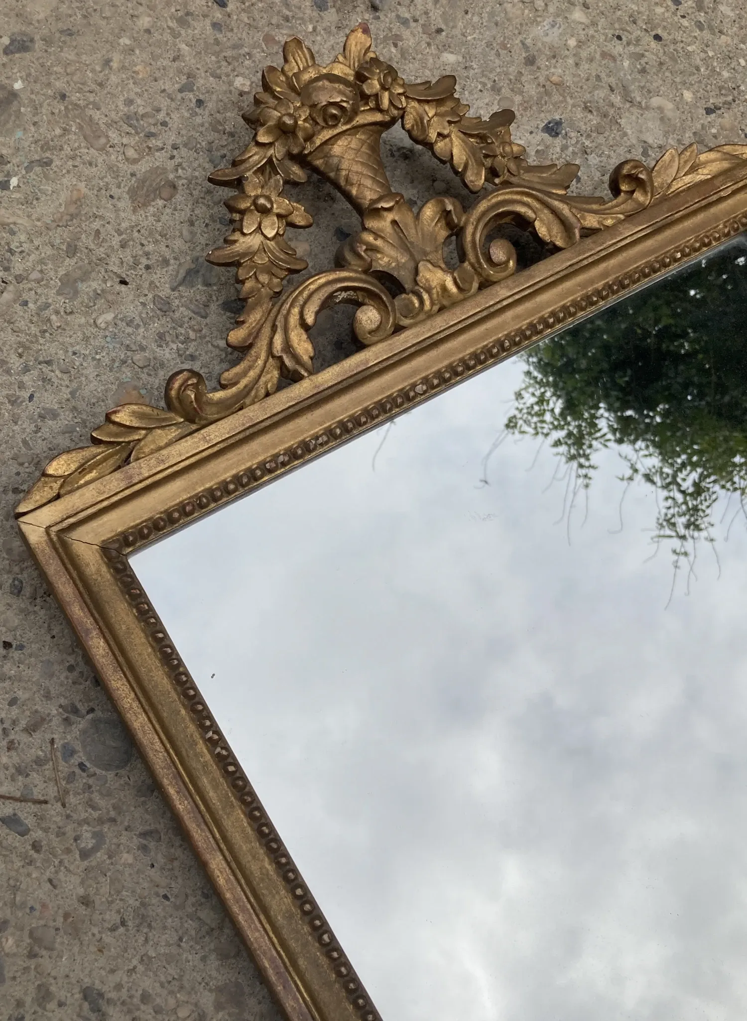 Antique mirror in wood and gilded stucco with a pediment - in the style of the 18th century.