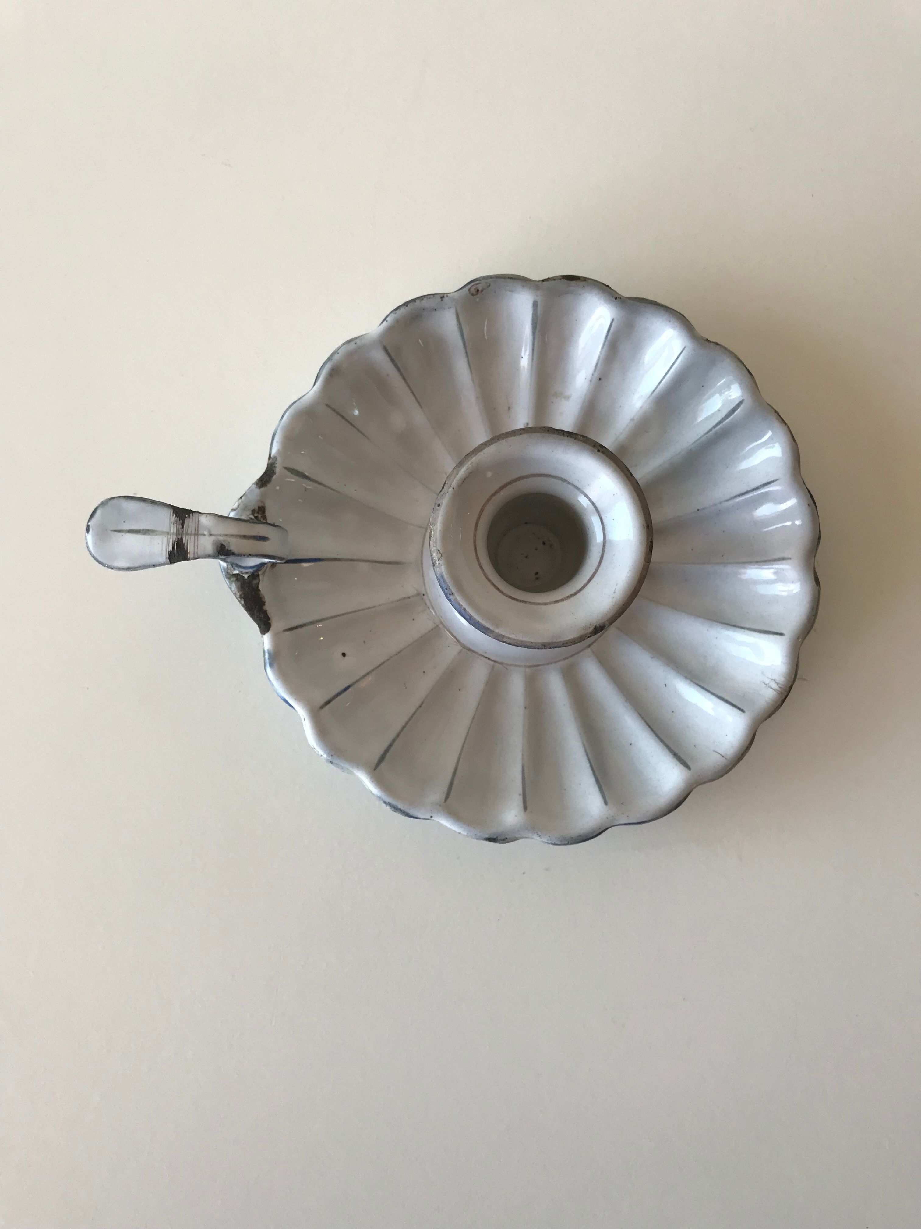 Candlestick in white enameled metal