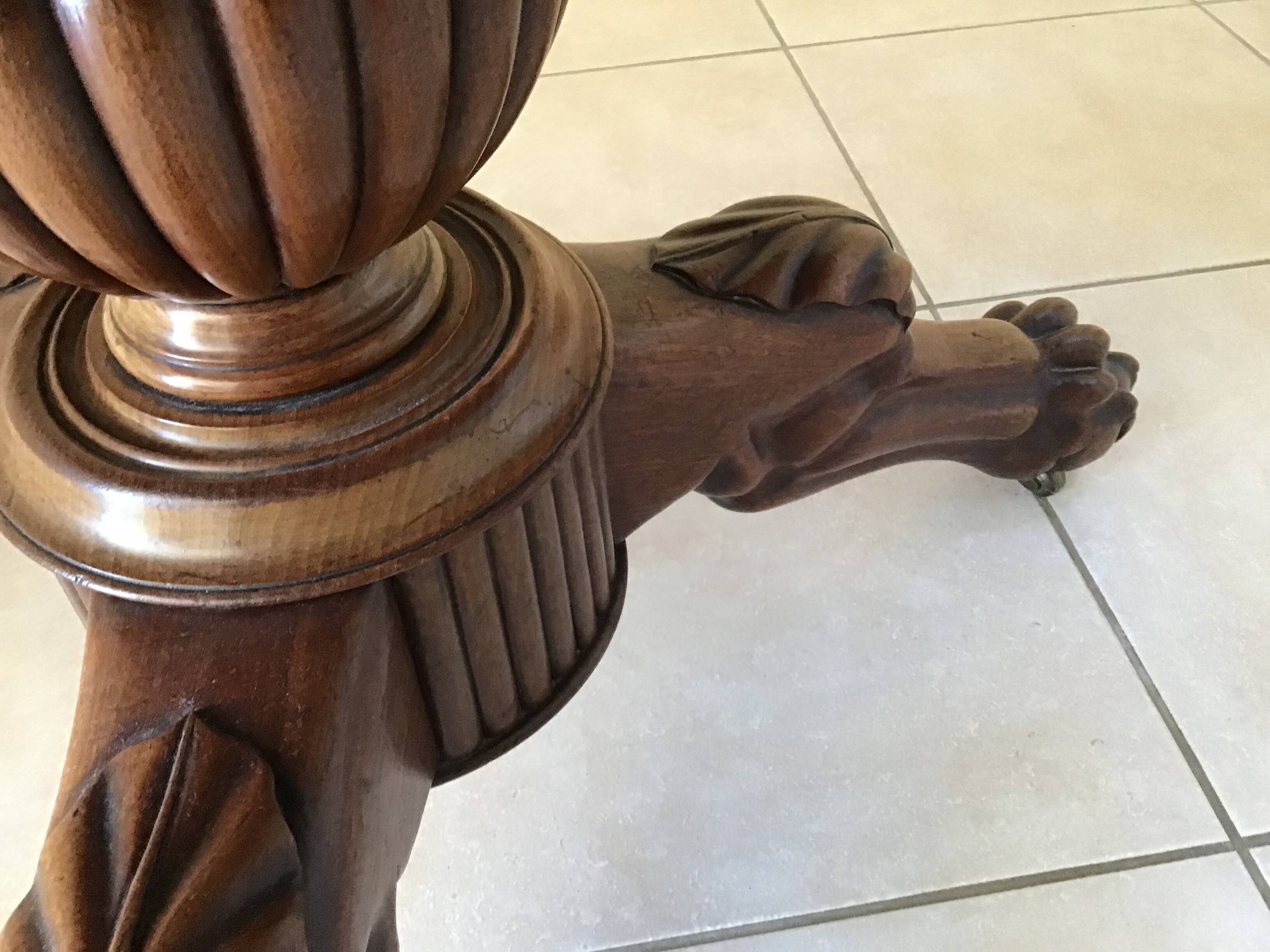 Wooden gueridon with marble, lion paw legs.