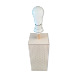 High foot of lace-up desing lamp, off-white background and beige patterns.