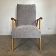 Vintage armchair reupholstered in light grey.