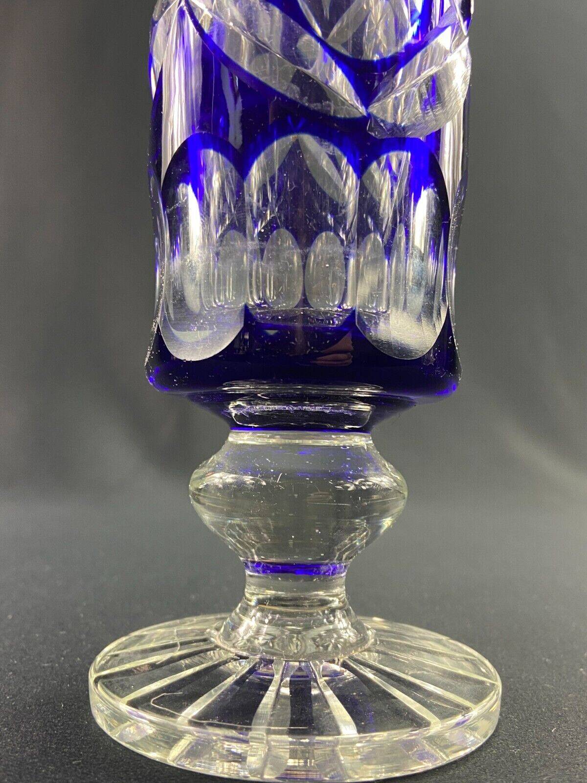 Tubular vase on a pedestal in cut blue Bohemian crystal.