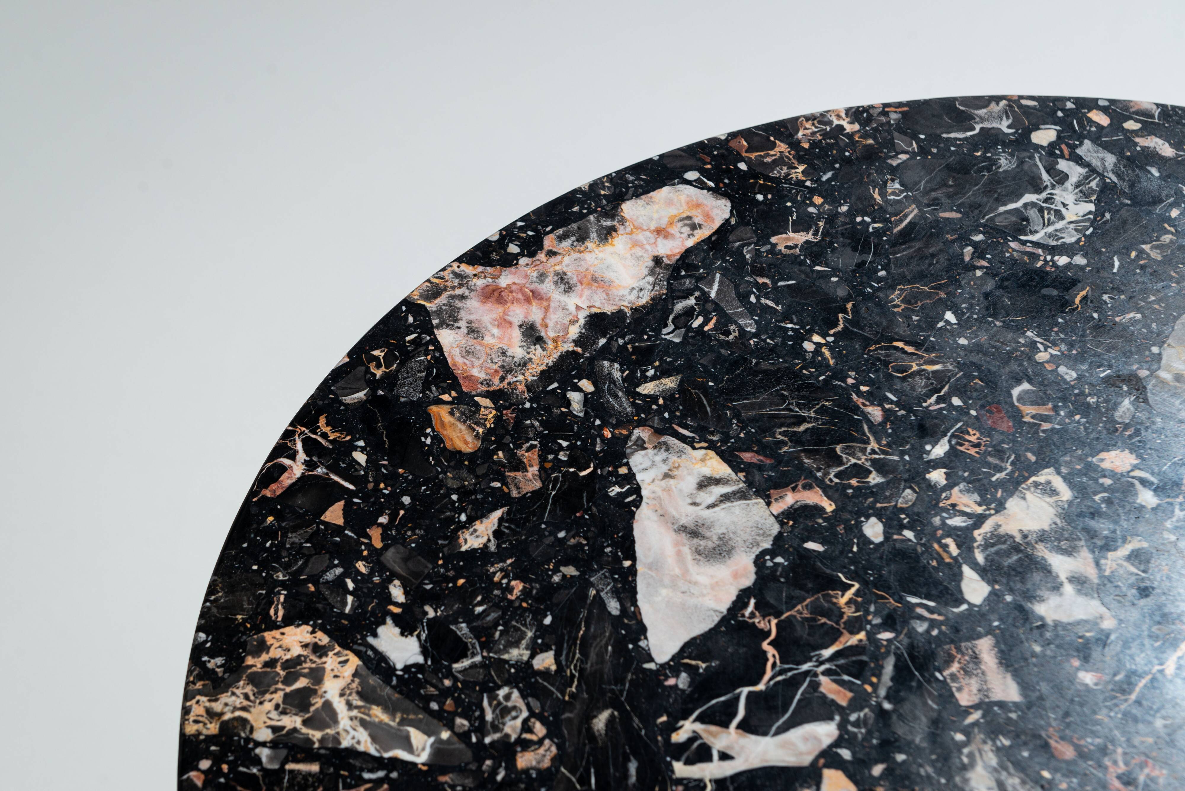 Round sidetable with stone top and three chromed legs