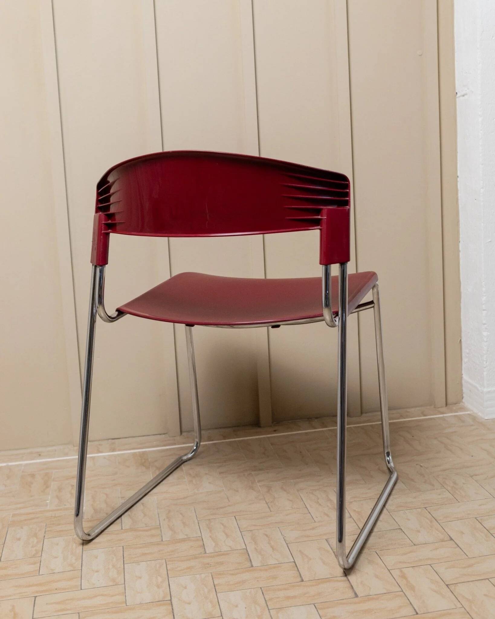 Red plastic-seat stacking chair with chrome frame by Paolo Favaretto for Assisa (Italy 1986) – vintage design