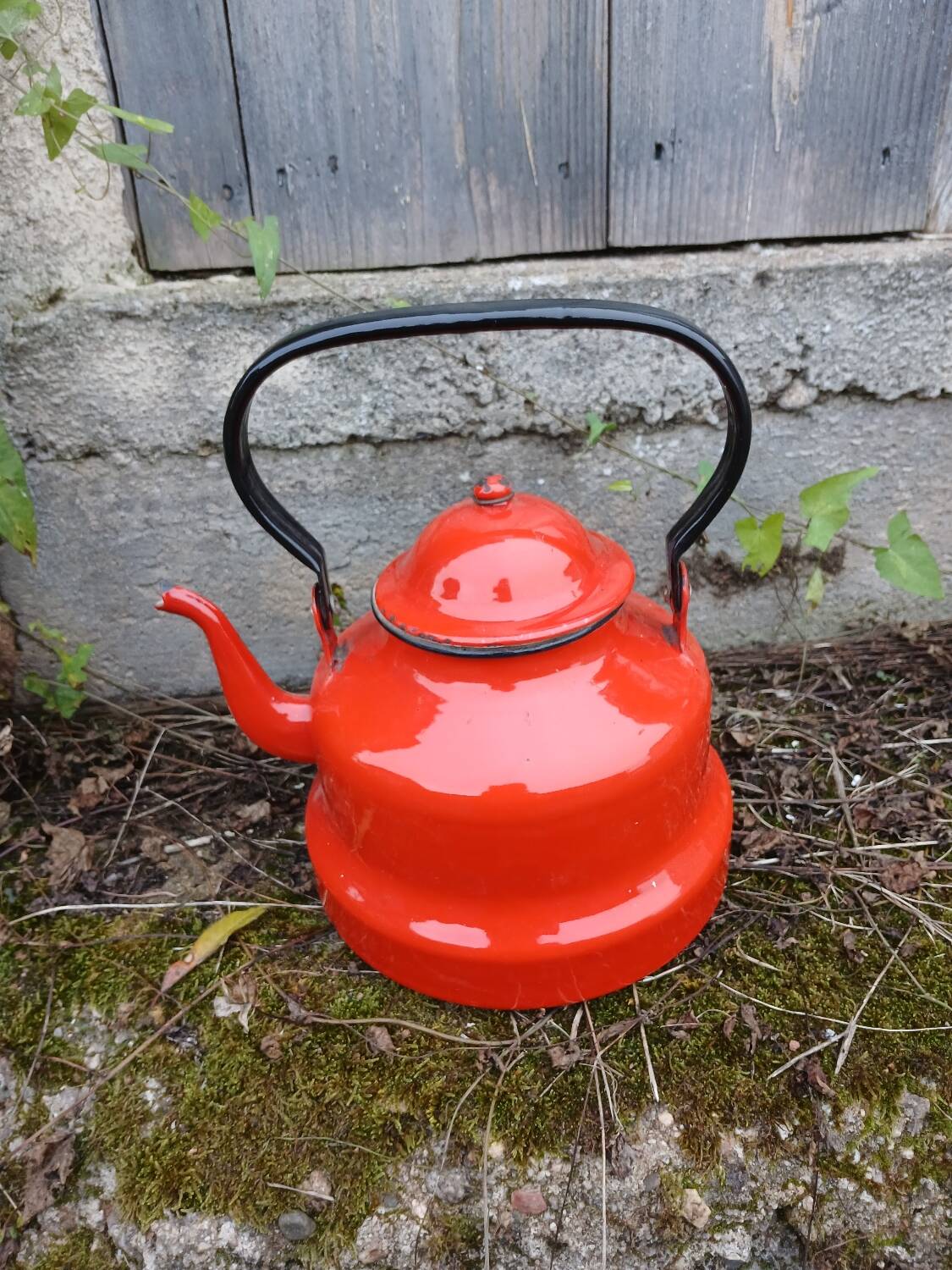 Antique teapot in red enamelled sheet metal