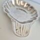 Silver-plated shell-shaped butter dishes, in the shape of a scallop shell.