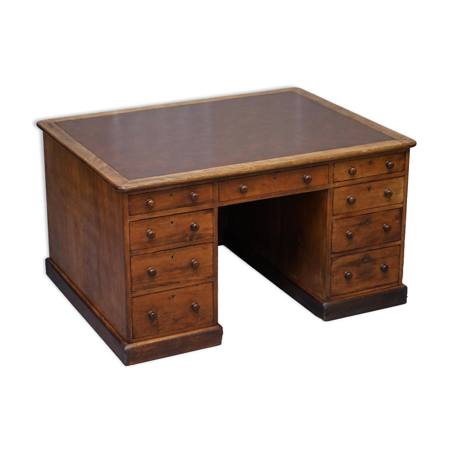 Antique Victorian oak kneehole desk with 18 double-sided drawers.