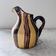 Striped decorative pitcher signed
