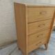 Vintage chest of drawers in raw wood.