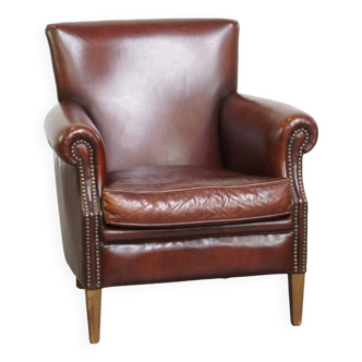 Comfortable, well-finished dark-colored sheep leather armchair