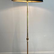 Neoclassical brass floor lamp with claw feet from Maison Jansen.