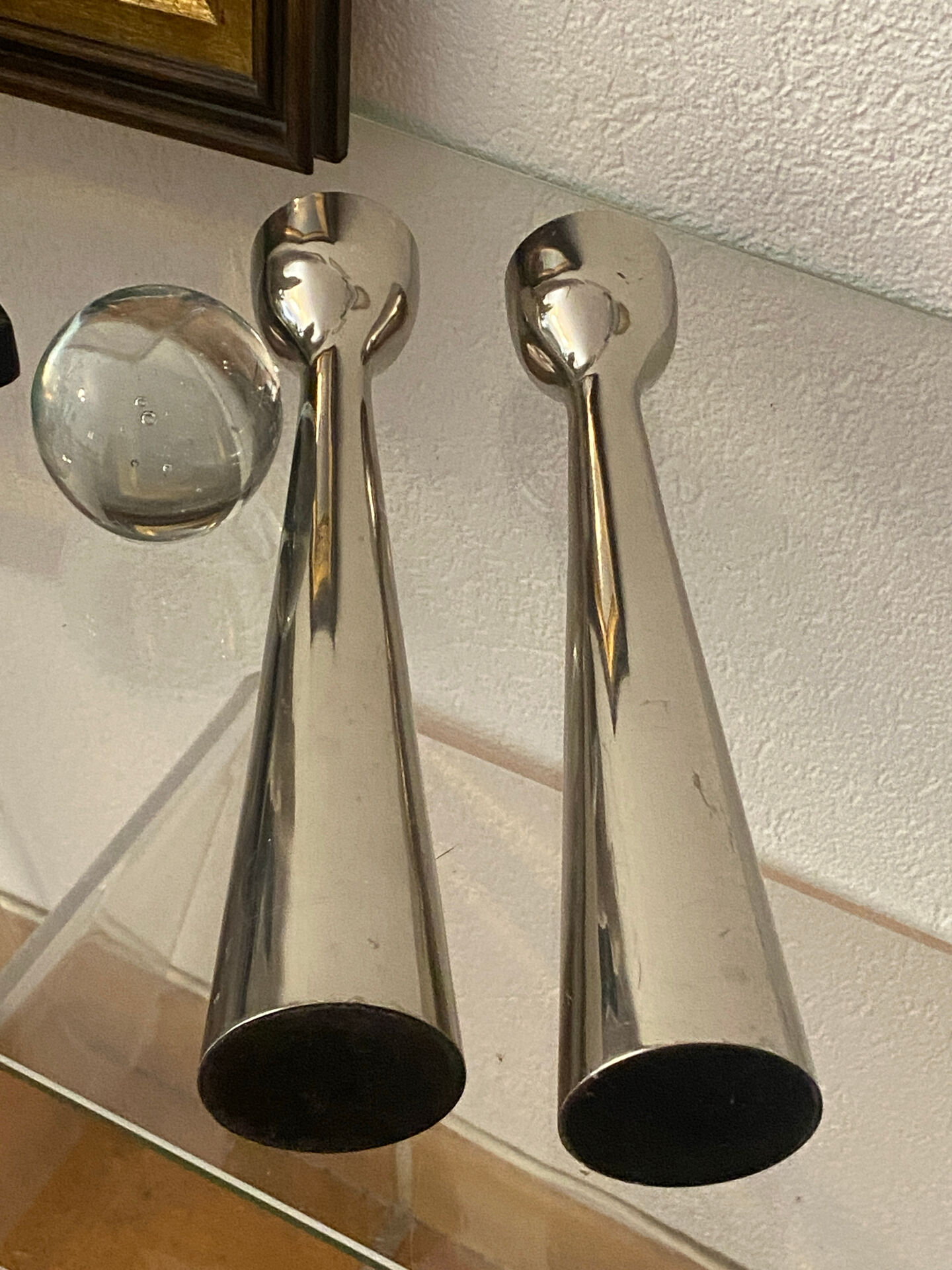 Pair of polished aluminium candlesticks