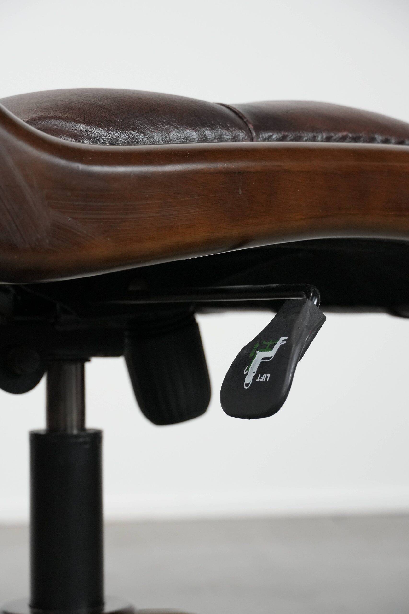 Chesterfield office chair in English style made of cow leather and wood.
