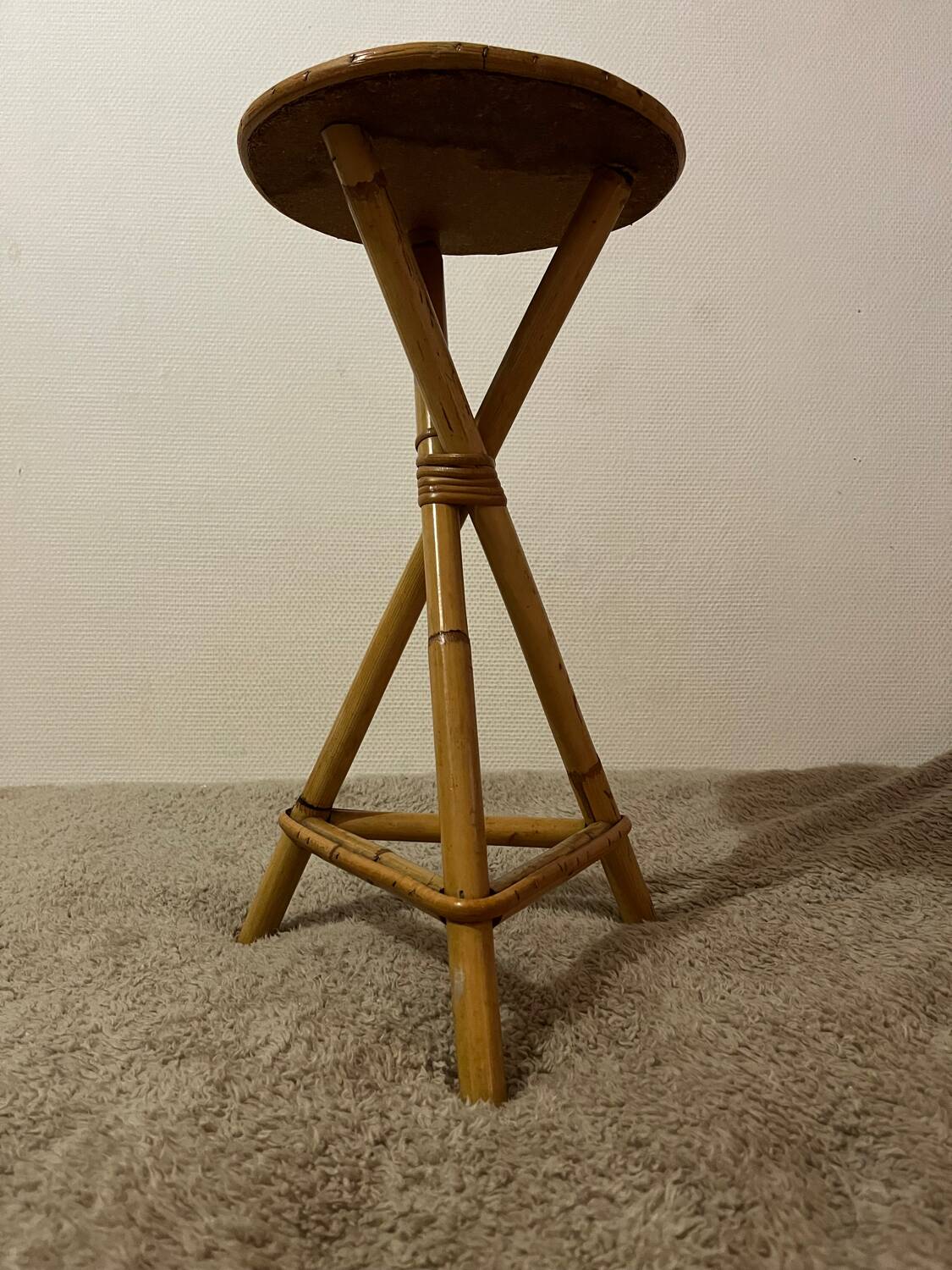 Plant holder or side table at the end of a bamboo sofa