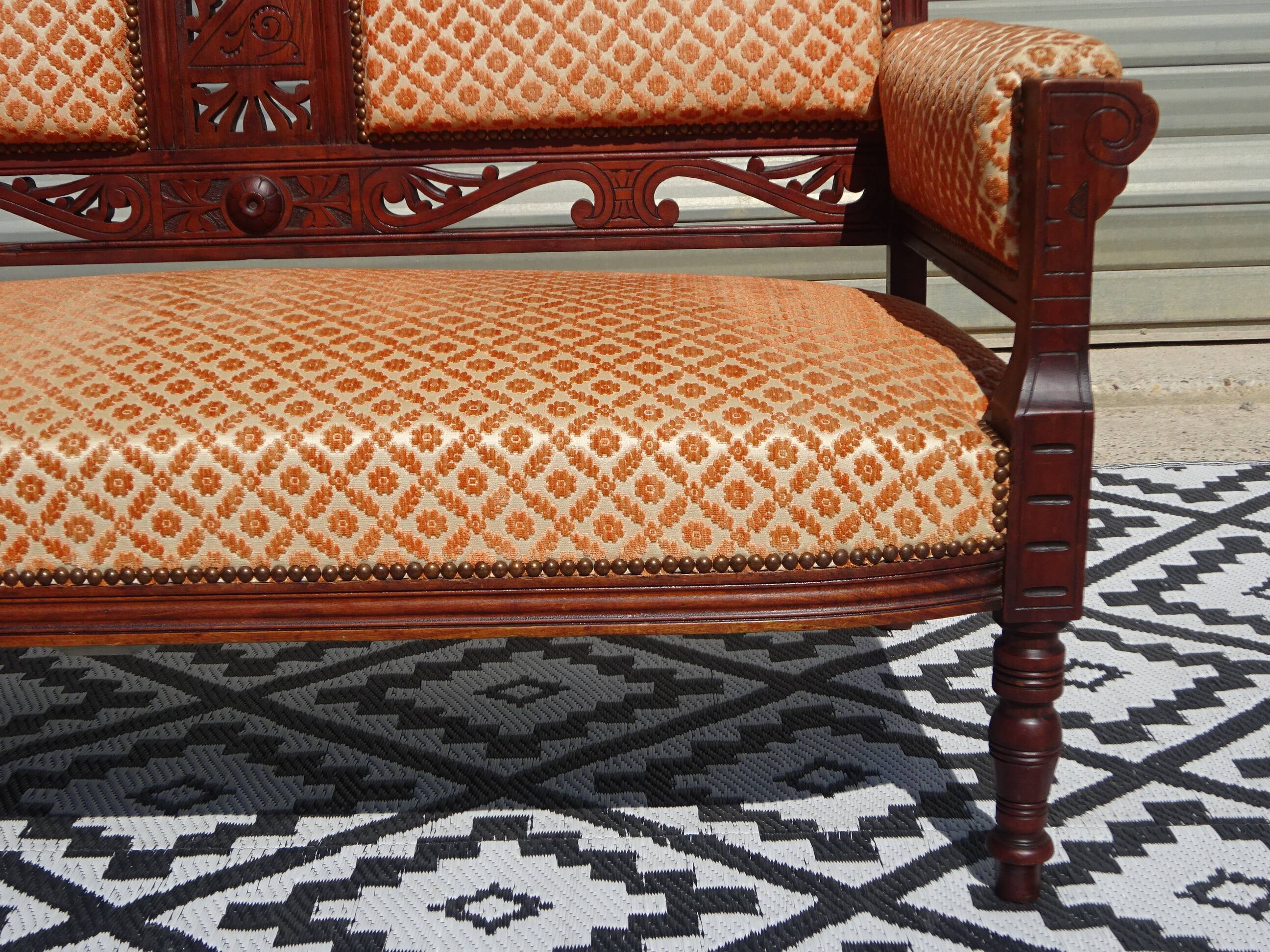 Old bench in wood and orange velvet