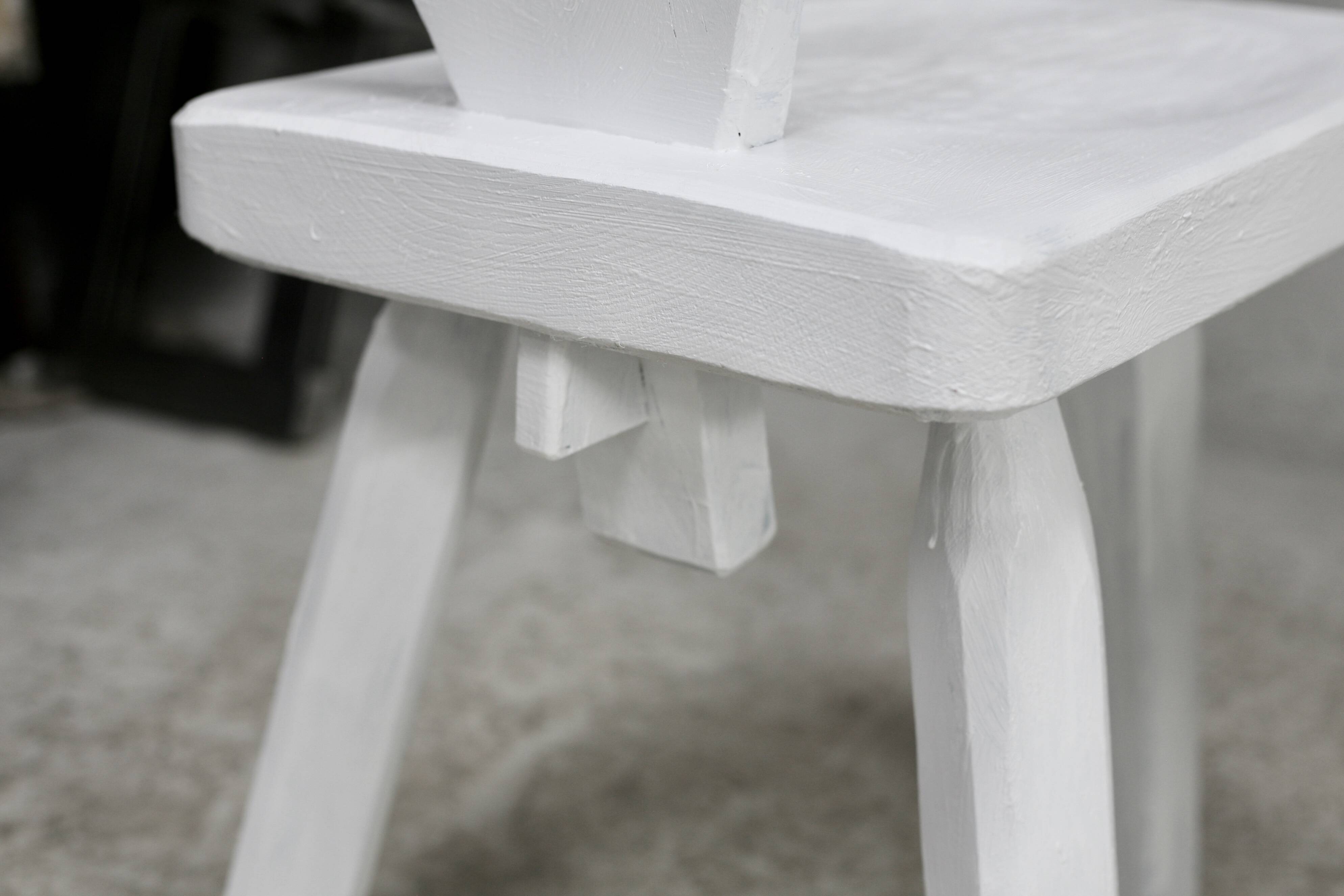 Pair of tripod chairs, gouged seats. Brutalist, circa 1960. Painted wood.