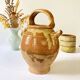 Old ochre and yellow glazed ceramic jug / goat
