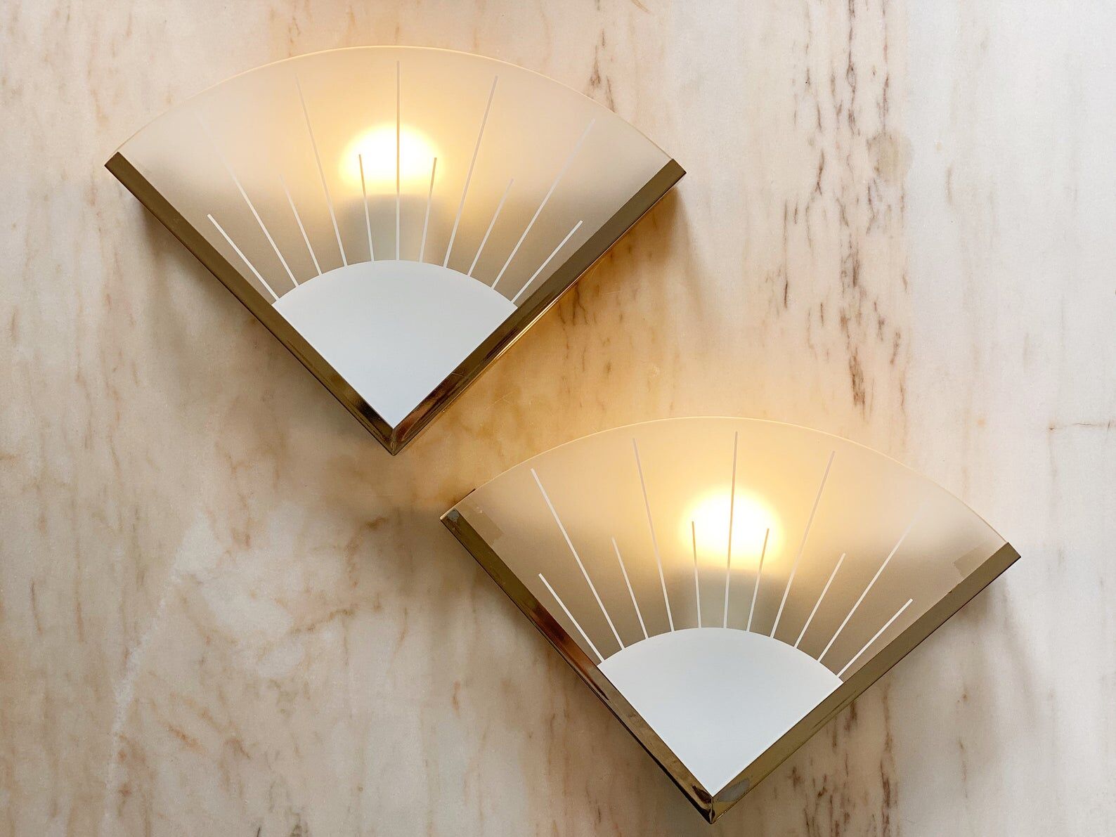 A pair of 80s hollywood regency glass & brass wall lamps