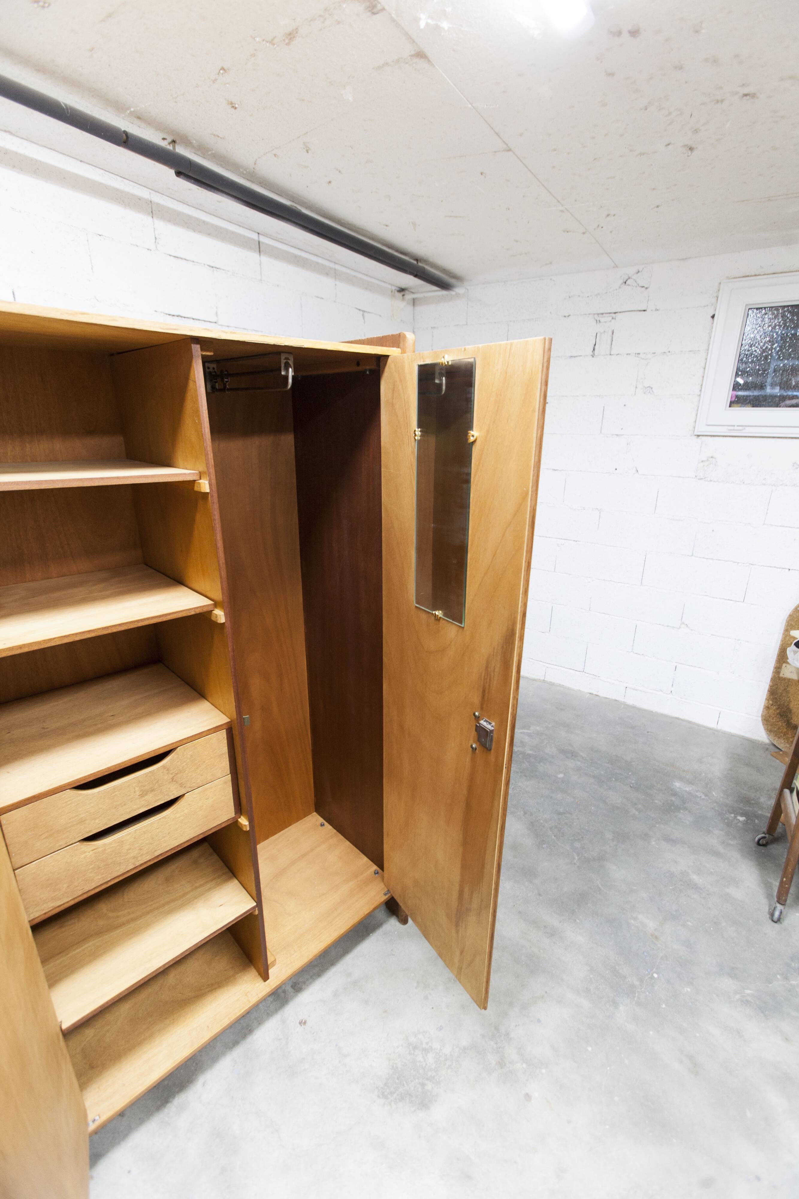 1950s Mid-Century Modern oak armoire with two doors and two drawers.