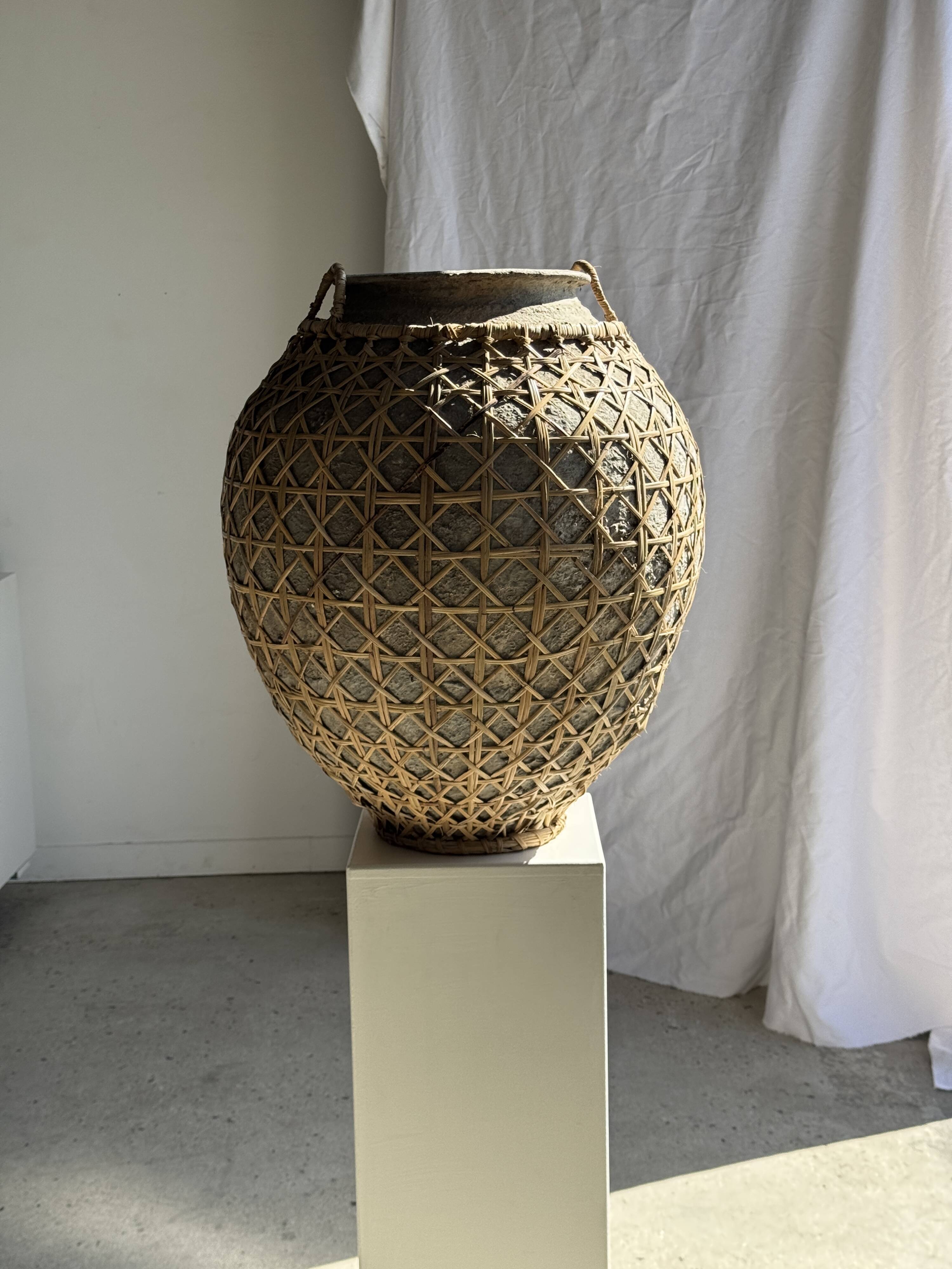 Immense light grey antique-style pot with a crosshatch lid and handles.