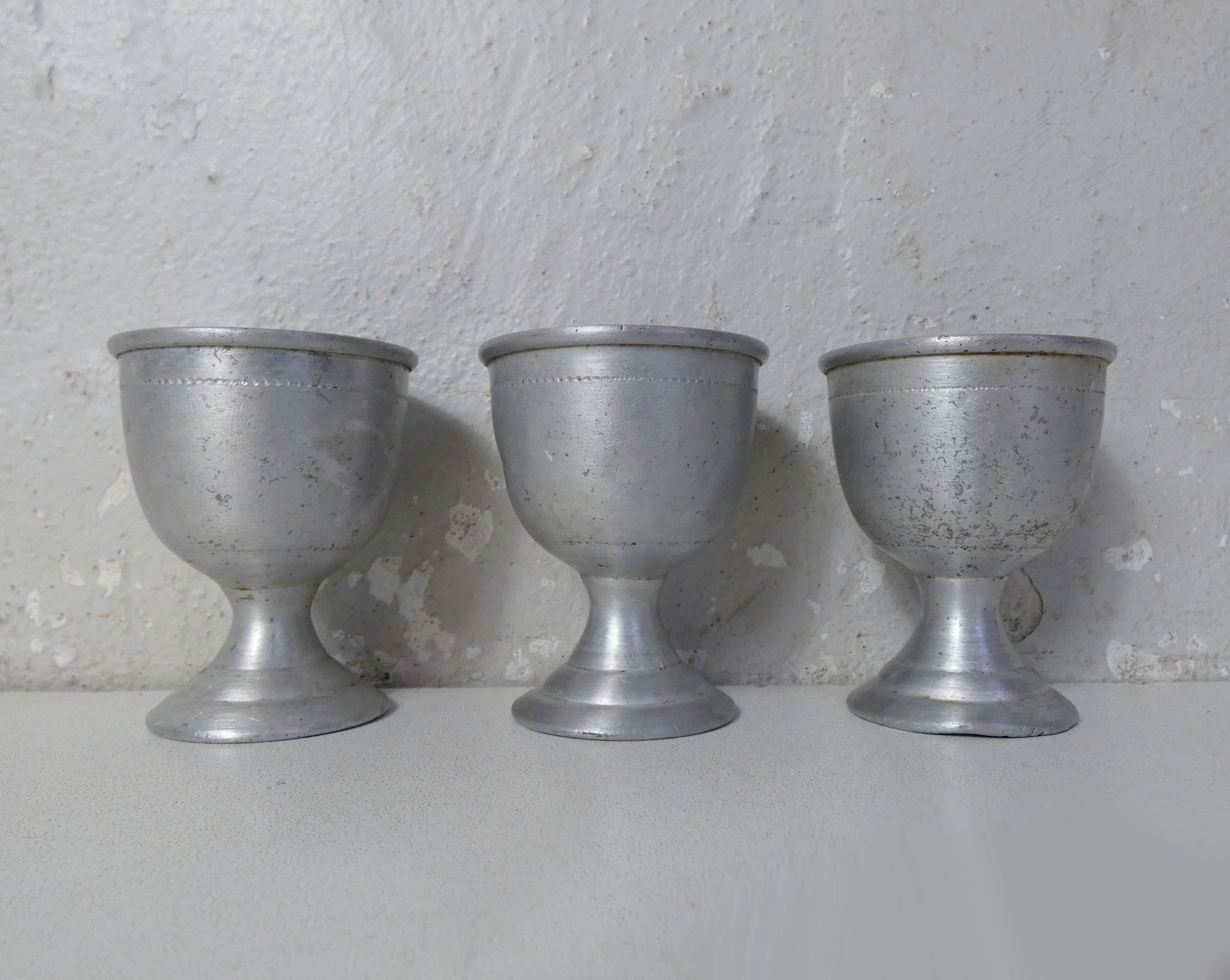 3 old aluminum shells