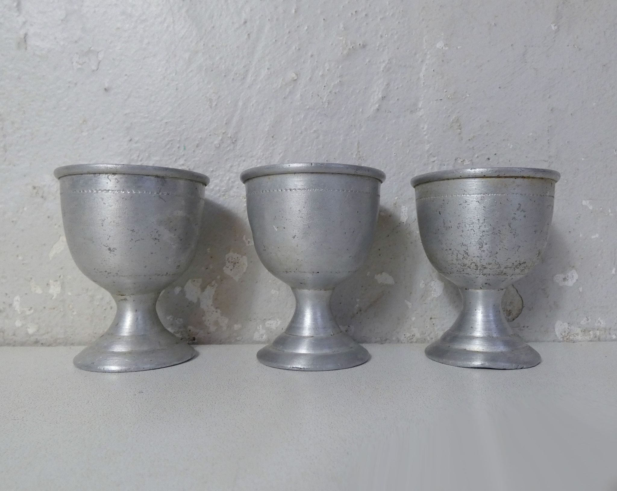 3 old aluminum shells