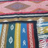 Traditional Berber tribal kilim rug with multicoloured geometric patterns.