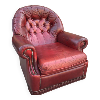 Burgundy leather club chair from the 1950s, with tufted back and studs.